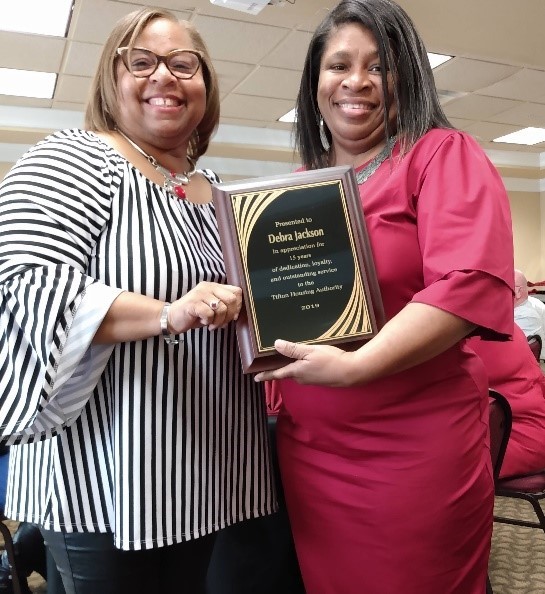 Ms Shaundra Clark, ED and Mrs. Jackson holding service recognition award placard