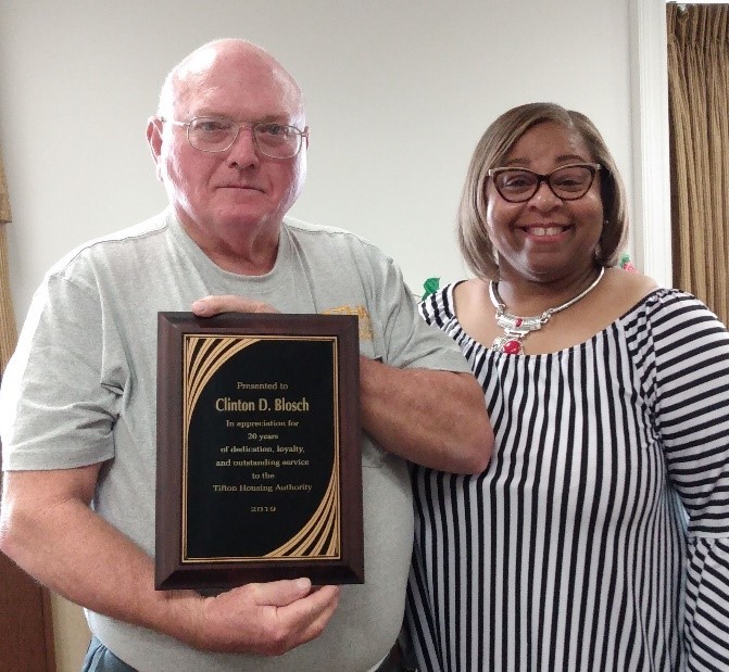 Mr. Blosch and Ms. Clark holding service recognition award placard