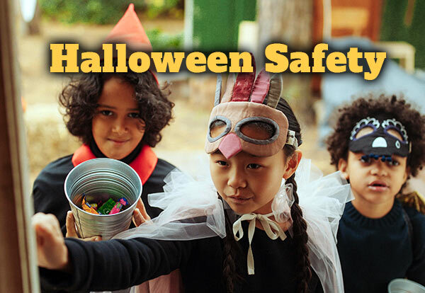 Three trick or treaters at a door with the text Halloween Safety.