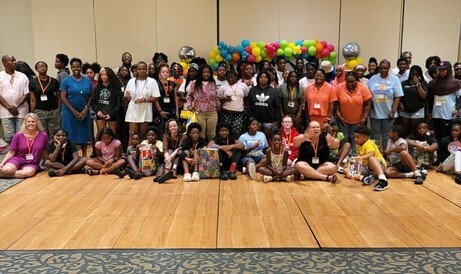 A group of conference attendees posing for a photo. 