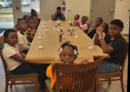 Children at a table making snowglobes at the Youth Center.