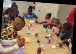 Kids at a table making snowglobes at the Youth Center.