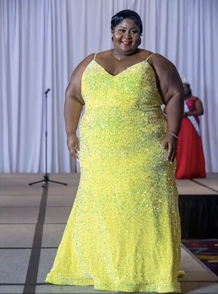 Seneca Clark stands smiling in her evening gown.