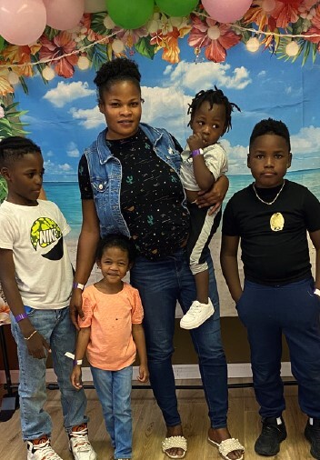 A lady with four children at the Family Fun Day Event.